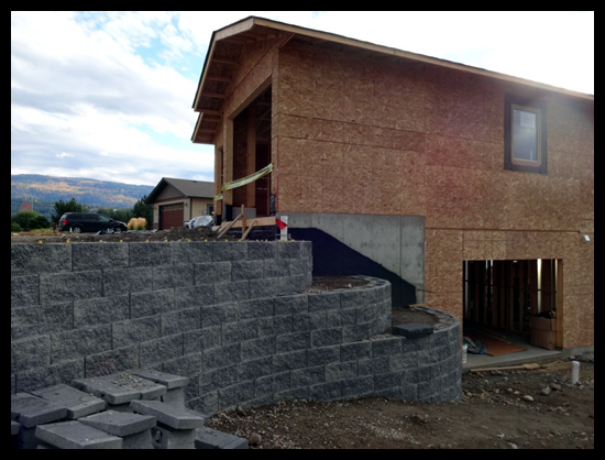 Building a Home in Coldstream, Third Month, custom electrical options and the retaining wall is coming together.